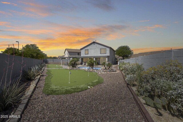 18103 W Canyon Ln, Goodyear, AZ 85338 - back of property with a fenced backyard, a patio area, and a fenced in pool