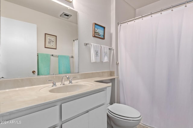 bathroom with visible vents, vanity, and toilet