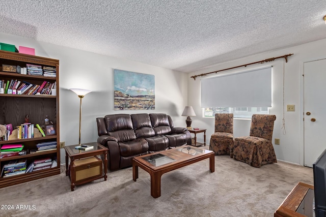 carpeted living room featuring a textured ceiling