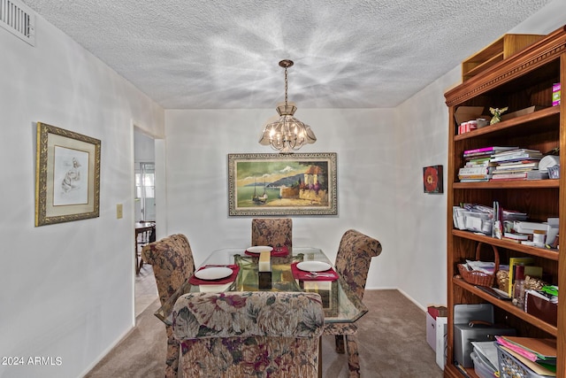 carpeted dining space with visible vents, a textured ceiling, baseboards, and an inviting chandelier