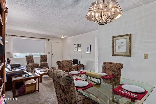 carpeted dining area with a notable chandelier and a textured ceiling