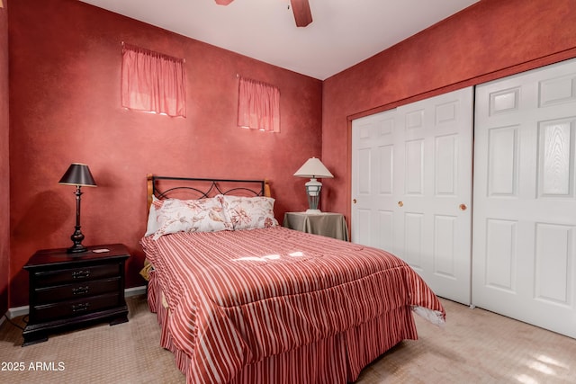 carpeted bedroom featuring ceiling fan and a closet