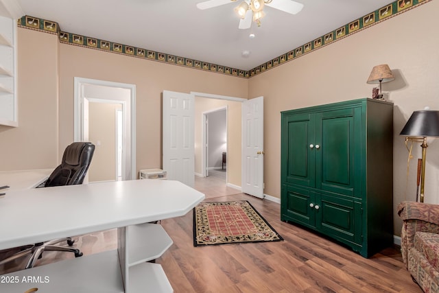 office space featuring ceiling fan and light hardwood / wood-style floors