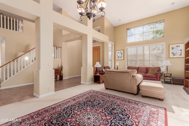 living room featuring a notable chandelier, light tile patterned flooring, and a high ceiling