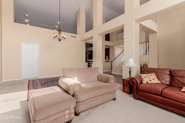 living room featuring carpet floors, a towering ceiling, and a notable chandelier