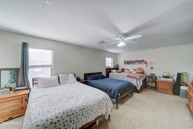 bedroom featuring light carpet and ceiling fan