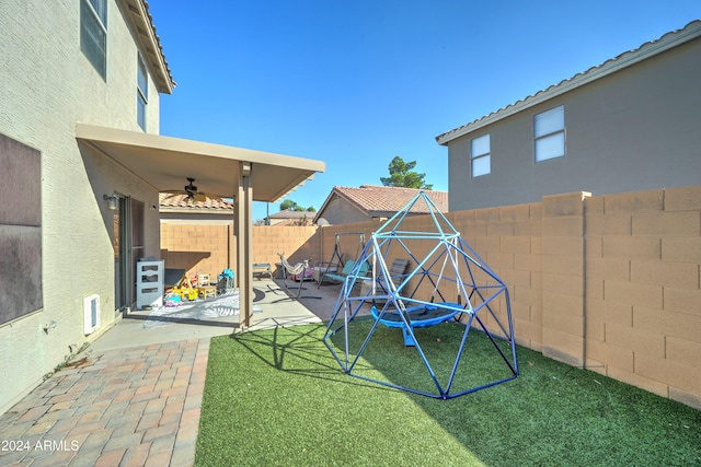 view of yard featuring a patio area and ceiling fan