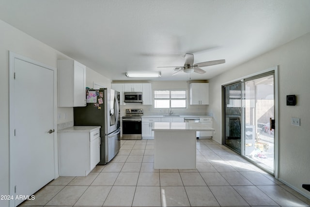 kitchen featuring appliances with stainless steel finishes, ceiling fan, white cabinetry, and light tile patterned flooring