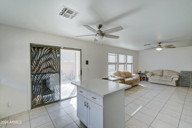 kitchen featuring white cabinets, ceiling fan, and light tile patterned floors