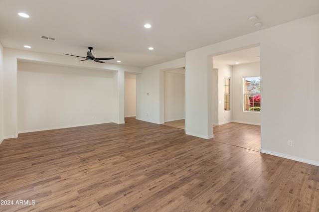 unfurnished room with a ceiling fan, visible vents, wood finished floors, and recessed lighting