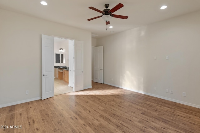 unfurnished bedroom with light wood finished floors, baseboards, and recessed lighting