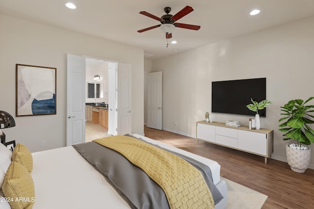 bedroom featuring light wood-type flooring, baseboards, and recessed lighting