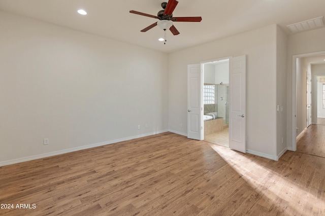 unfurnished bedroom with light wood-type flooring, connected bathroom, and ceiling fan