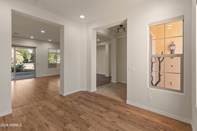 unfurnished room featuring visible vents, baseboards, wood finished floors, and recessed lighting