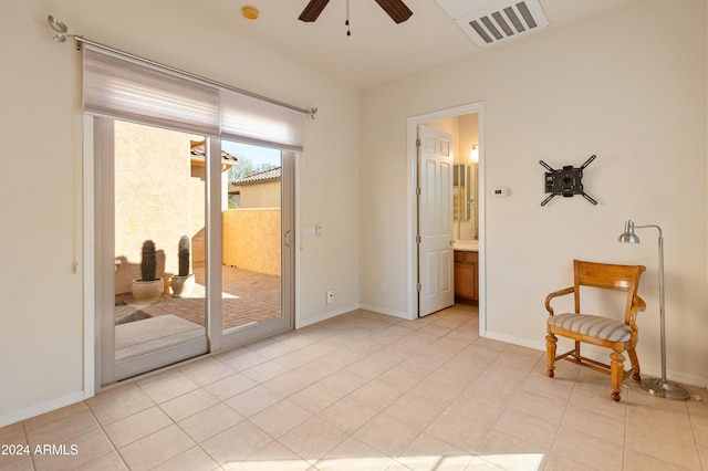 empty room with visible vents, ceiling fan, baseboards, and light tile patterned floors