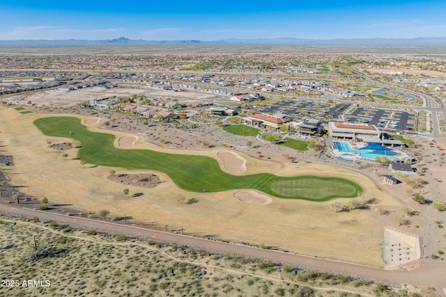 drone / aerial view with a mountain view and golf course view