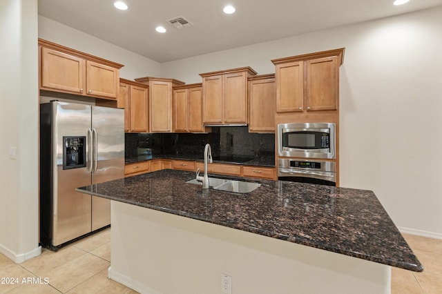 kitchen featuring stainless steel appliances, visible vents, backsplash, light tile patterned flooring, and a sink