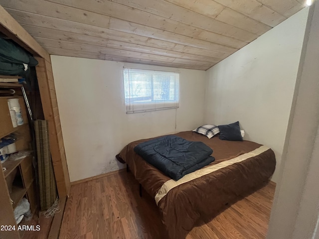 bedroom with hardwood / wood-style flooring and wooden ceiling