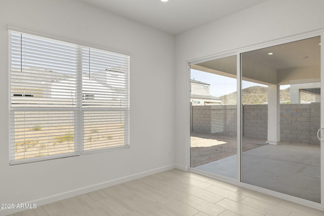 empty room with baseboards and recessed lighting