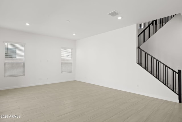 unfurnished living room with visible vents, recessed lighting, stairs, and plenty of natural light