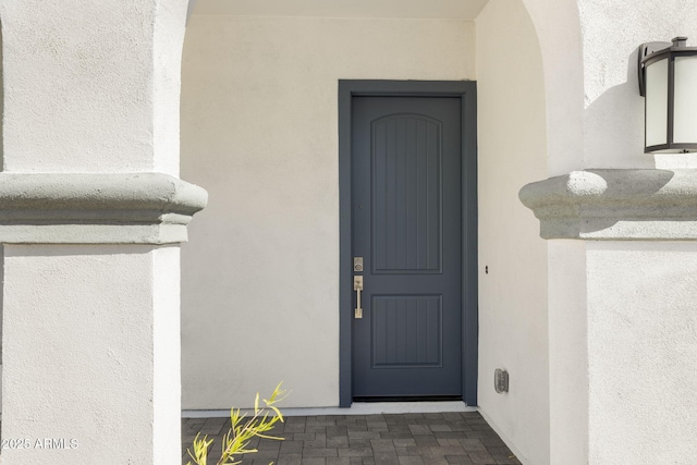 property entrance featuring stucco siding
