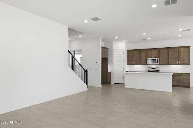 kitchen featuring light countertops, recessed lighting, appliances with stainless steel finishes, and visible vents
