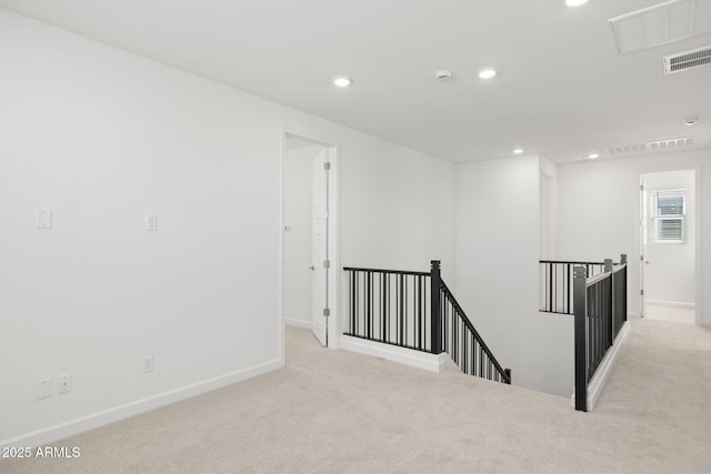carpeted empty room with baseboards, recessed lighting, and visible vents