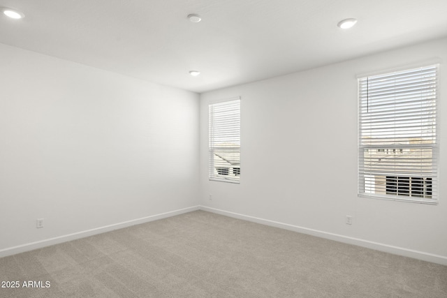 unfurnished room featuring recessed lighting, baseboards, and light colored carpet