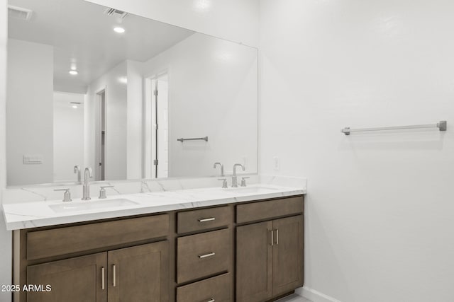 bathroom featuring visible vents, a sink, double vanity, and recessed lighting