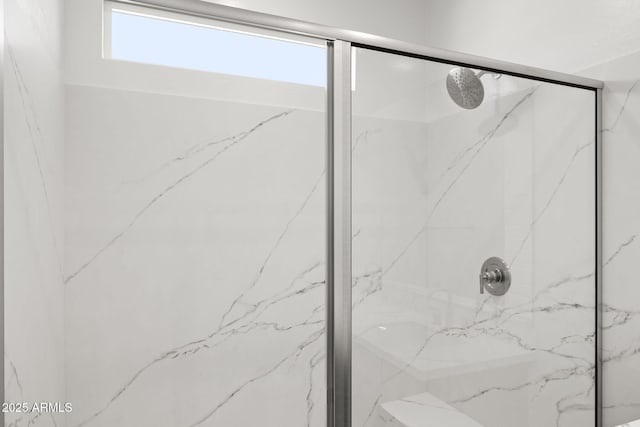 bathroom with a marble finish shower