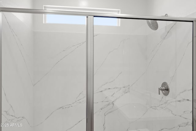 full bathroom featuring a marble finish shower