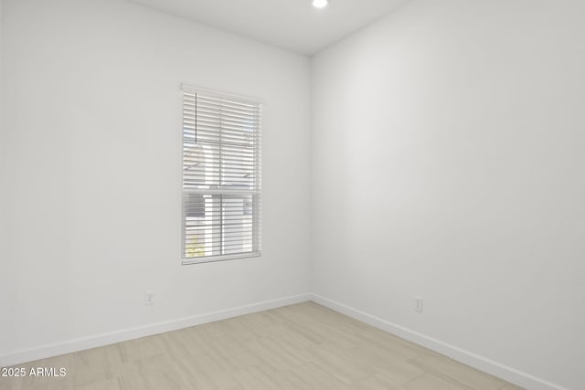 empty room with baseboards and recessed lighting