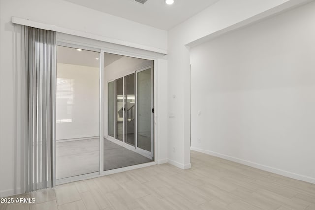 empty room with baseboards and recessed lighting