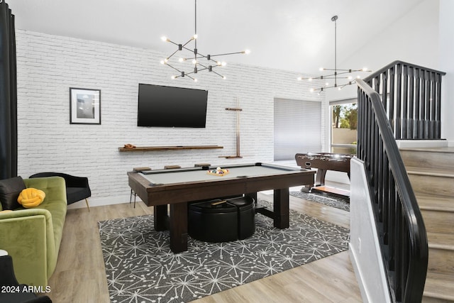 rec room featuring pool table, brick wall, and hardwood / wood-style flooring