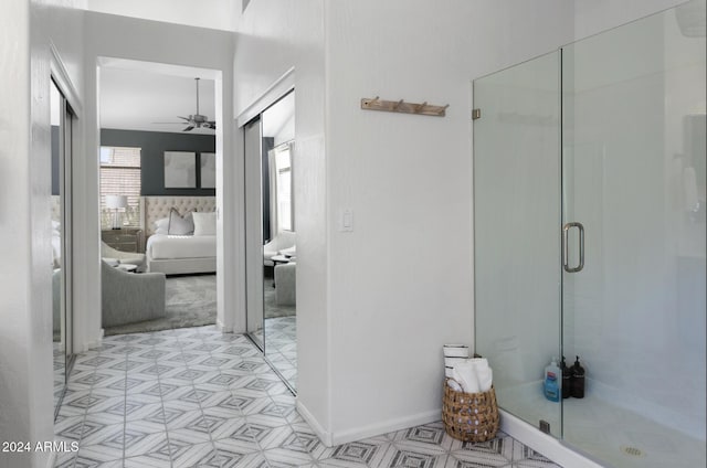 bathroom featuring walk in shower and ceiling fan