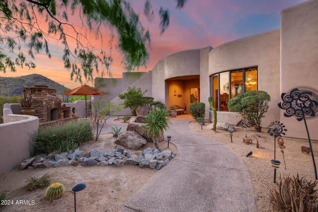 exterior space featuring a patio and an outdoor stone fireplace