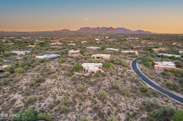 aerial view at dusk featuring a mountain view