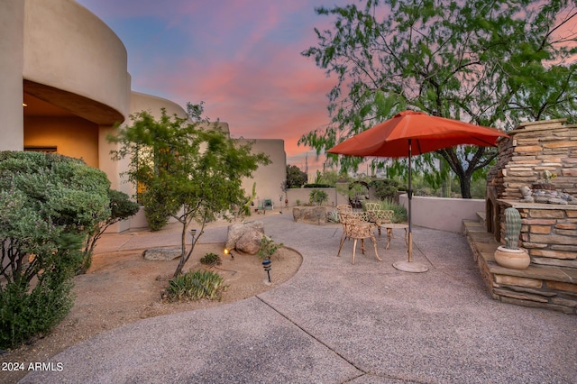 view of patio terrace at dusk