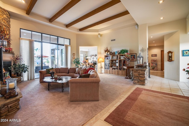 living room featuring light tile patterned flooring, a fireplace, and a high ceiling