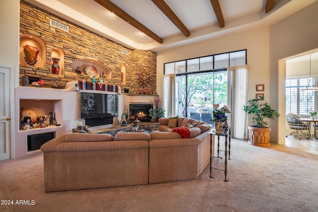 carpeted living room featuring beam ceiling and a high ceiling