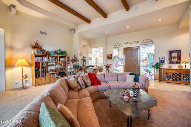 carpeted living room with beamed ceiling