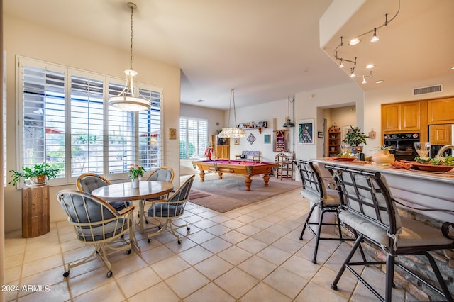 dining room with light tile patterned flooring, a healthy amount of sunlight, and pool table