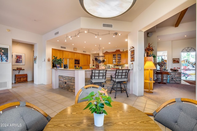 tiled dining area with beam ceiling