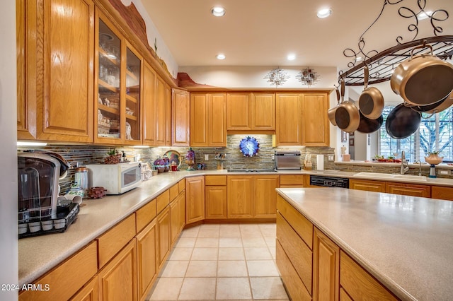 kitchen with dishwasher, sink, gas stovetop, tasteful backsplash, and light tile patterned floors