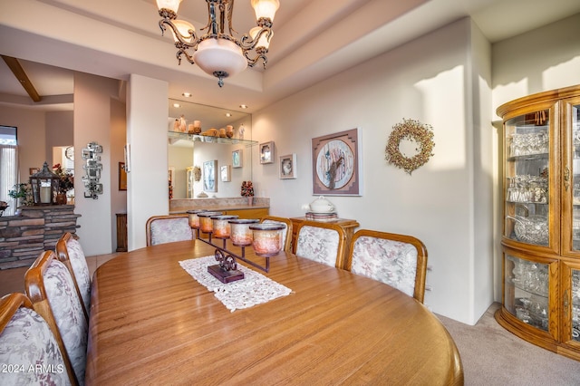 carpeted dining room featuring an inviting chandelier