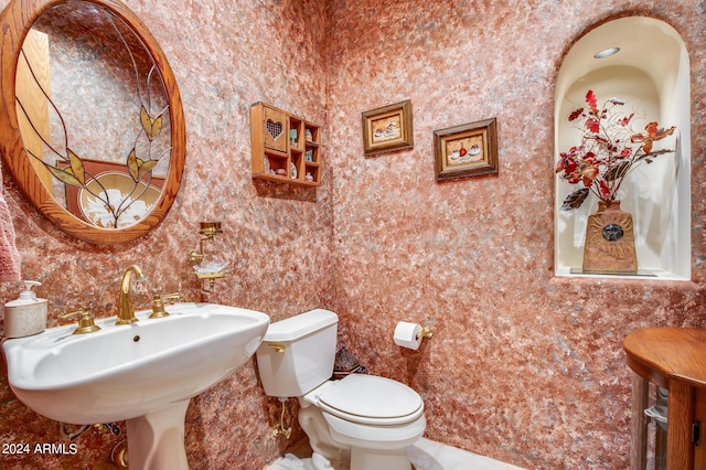 bathroom featuring sink, tile patterned flooring, and toilet