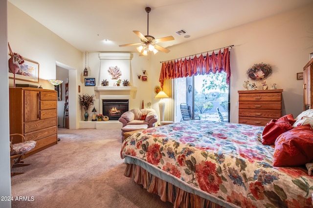 carpeted bedroom with ceiling fan and a wall mounted air conditioner