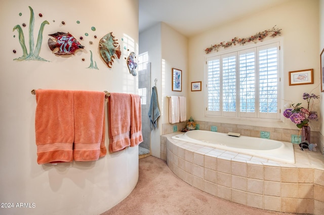 bathroom featuring a relaxing tiled tub