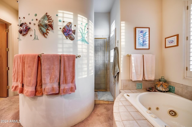 bathroom featuring separate shower and tub