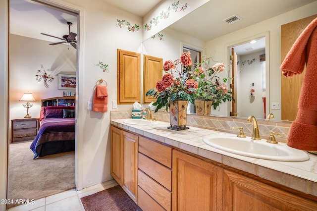 bathroom with tile patterned floors, ceiling fan, backsplash, and vanity